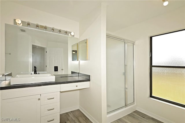 bathroom with vanity, a shower with door, and hardwood / wood-style floors