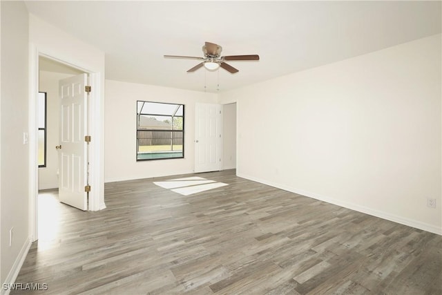 unfurnished room featuring hardwood / wood-style floors and ceiling fan