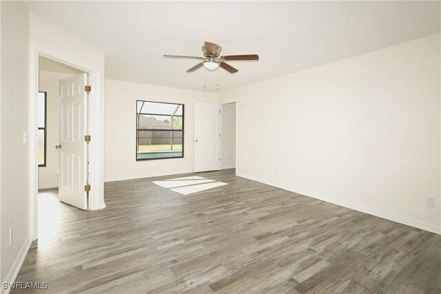 empty room featuring ceiling fan and hardwood / wood-style floors