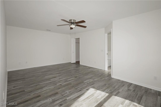 spare room with ceiling fan and dark hardwood / wood-style flooring