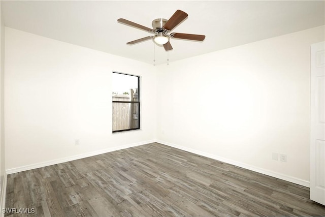 unfurnished room with dark hardwood / wood-style flooring and ceiling fan