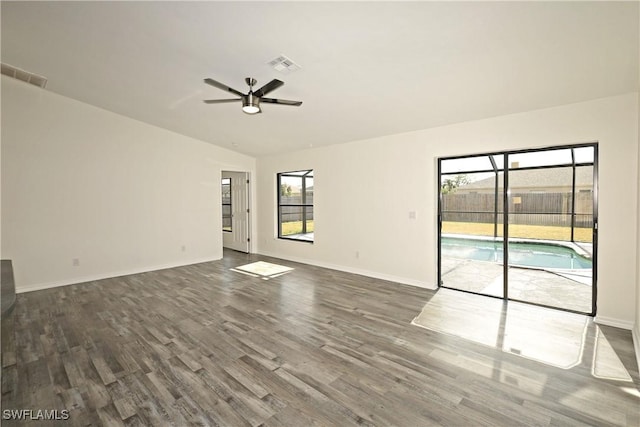 unfurnished living room with vaulted ceiling, ceiling fan, and dark hardwood / wood-style floors