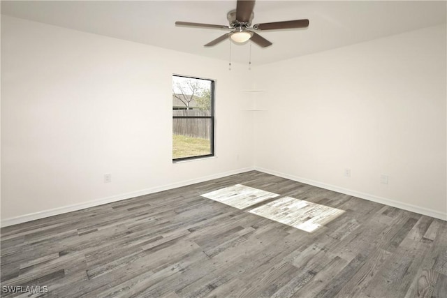 unfurnished room with ceiling fan and dark hardwood / wood-style flooring