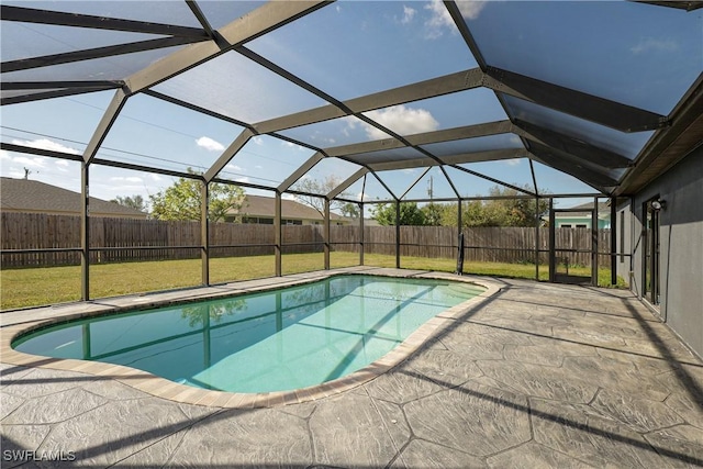 view of swimming pool featuring a patio, a yard, and glass enclosure