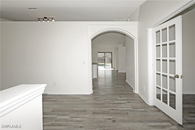 hallway with wood-type flooring