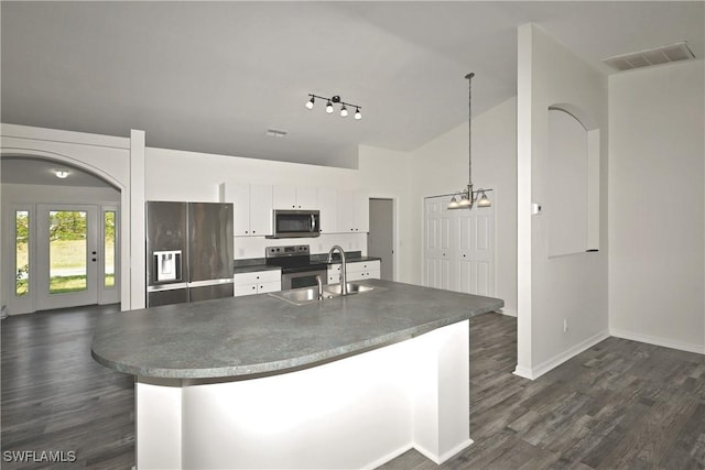 kitchen with appliances with stainless steel finishes, sink, an inviting chandelier, pendant lighting, and white cabinets