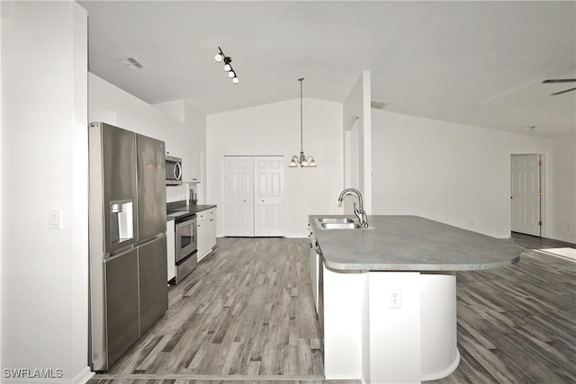 kitchen with white cabinetry, sink, pendant lighting, lofted ceiling, and appliances with stainless steel finishes