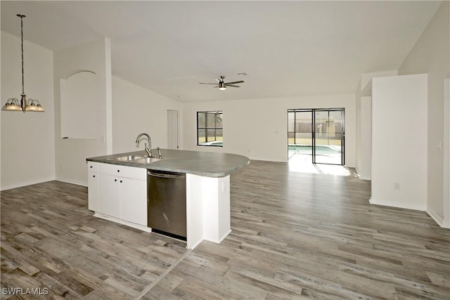 kitchen with stainless steel dishwasher, ceiling fan with notable chandelier, sink, white cabinets, and hanging light fixtures