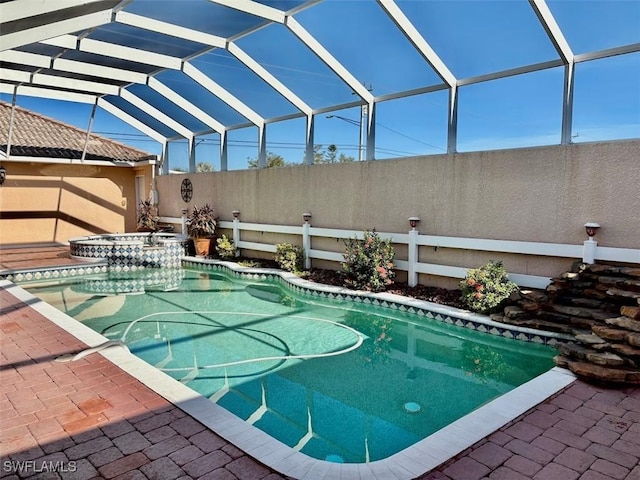 view of swimming pool with glass enclosure