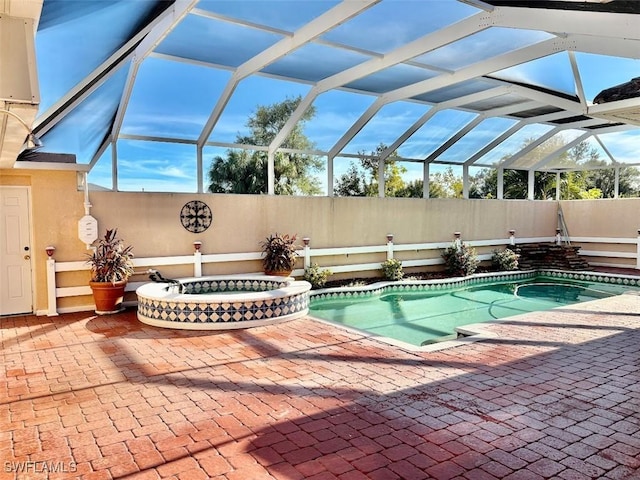 view of swimming pool featuring glass enclosure and a patio area