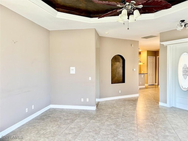 empty room featuring a raised ceiling, ceiling fan, crown molding, and light tile patterned floors