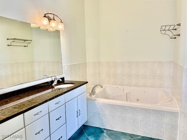 bathroom featuring tile patterned floors, vanity, and tiled bath