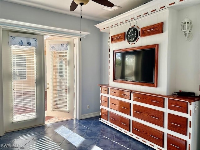 entryway featuring ceiling fan and dark tile patterned floors