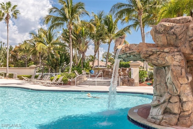 view of pool with pool water feature and a patio area