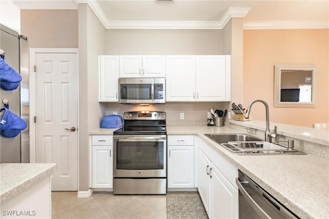 kitchen with crown molding, sink, light tile patterned floors, white cabinetry, and stainless steel appliances