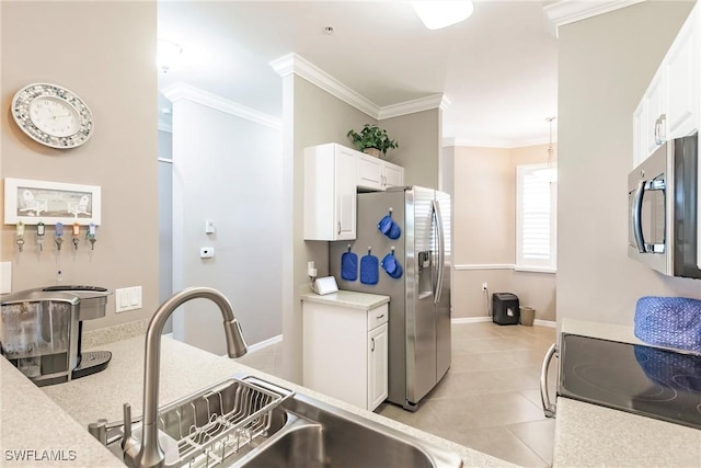 kitchen featuring light tile patterned floors, stainless steel appliances, white cabinetry, and sink