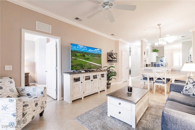 living room featuring light tile patterned floors, ceiling fan with notable chandelier, and ornamental molding