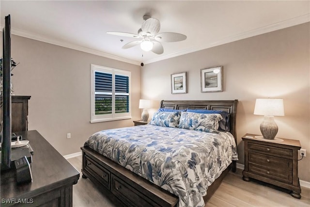 bedroom featuring ceiling fan, light hardwood / wood-style flooring, and crown molding