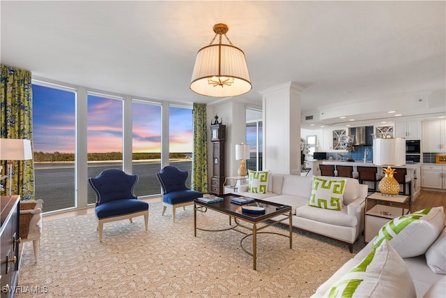 living room with recessed lighting, wood finished floors, and floor to ceiling windows