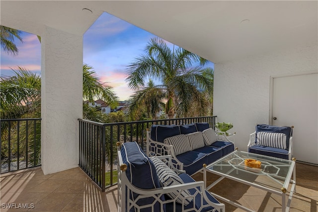 balcony at dusk featuring an outdoor hangout area