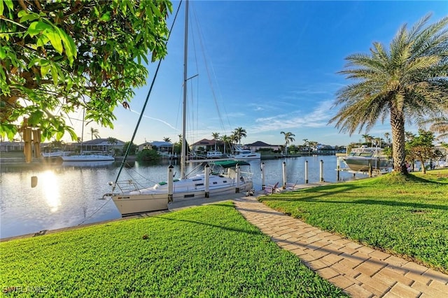 dock area featuring a lawn and a water view