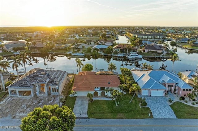 aerial view at dusk with a water view