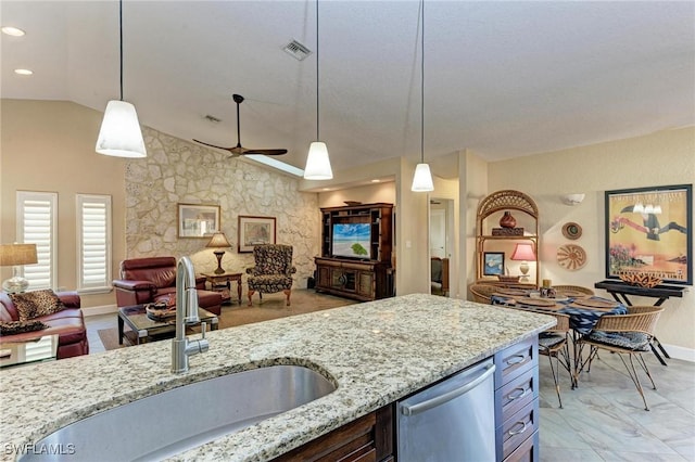 kitchen featuring dishwasher, sink, hanging light fixtures, and vaulted ceiling