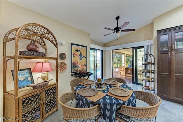 tiled dining area featuring ceiling fan and vaulted ceiling