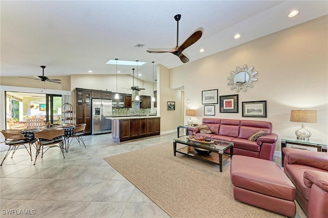 tiled living room featuring ceiling fan and high vaulted ceiling