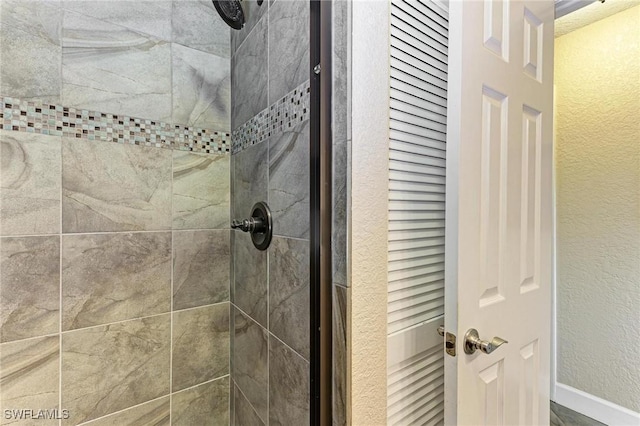 bathroom with tiled shower