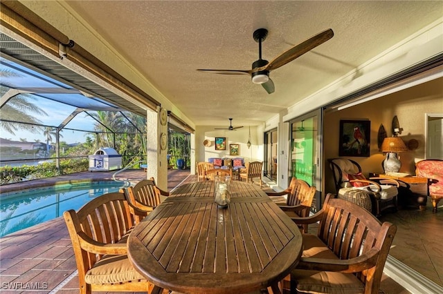 view of patio / terrace featuring ceiling fan, a lanai, an outdoor hangout area, and grilling area