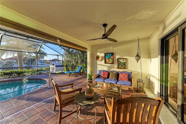 view of patio / terrace featuring outdoor lounge area, ceiling fan, and a lanai