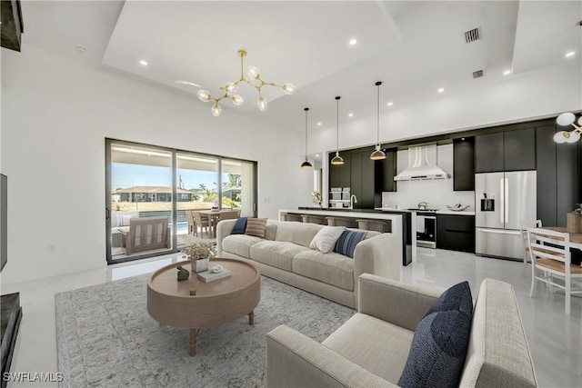 living room featuring a notable chandelier and a towering ceiling