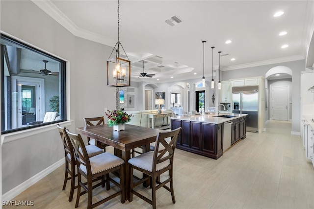 dining area featuring beamed ceiling, ornamental molding, coffered ceiling, and sink