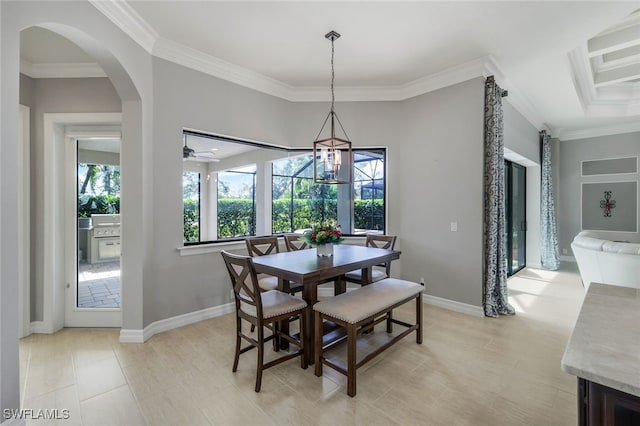 tiled dining space with ceiling fan with notable chandelier and ornamental molding