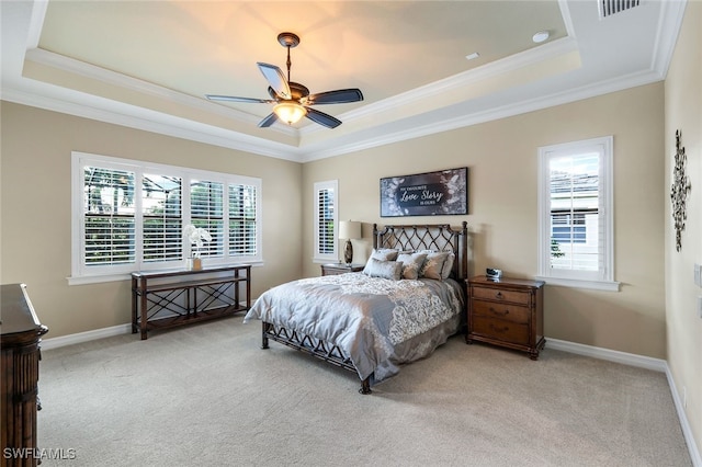 bedroom featuring light carpet, a raised ceiling, ceiling fan, and crown molding