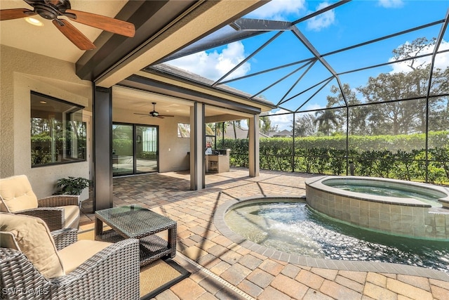 view of patio / terrace featuring an in ground hot tub, glass enclosure, and ceiling fan