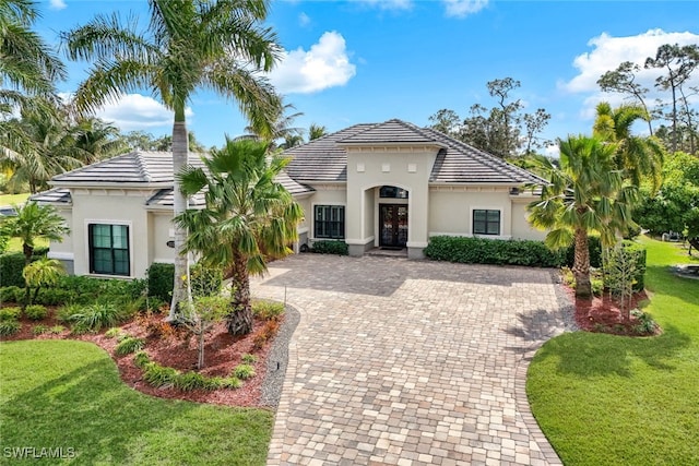 mediterranean / spanish house with a front lawn