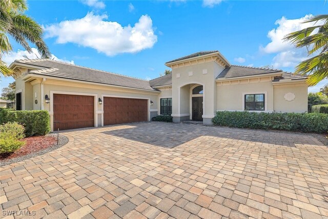 mediterranean / spanish-style house with a garage