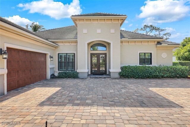 entrance to property with french doors and a garage