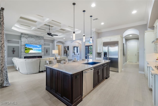 kitchen featuring a kitchen island with sink, white cabinets, stainless steel appliances, and coffered ceiling