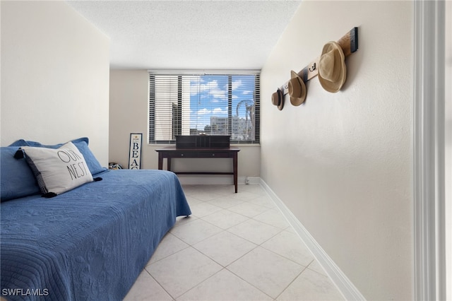 tiled bedroom with a textured ceiling