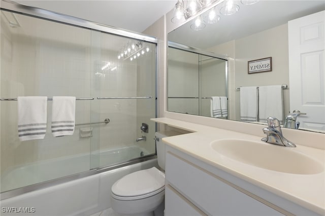 full bathroom featuring vanity, toilet, and shower / bath combination with glass door