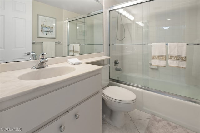 full bathroom with tile patterned flooring, enclosed tub / shower combo, vanity, and toilet