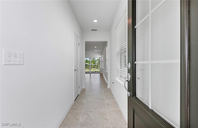 hall with recessed lighting, visible vents, and baseboards