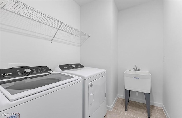 laundry room with laundry area, baseboards, and separate washer and dryer