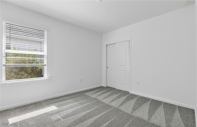 spare room with carpet flooring and baseboards