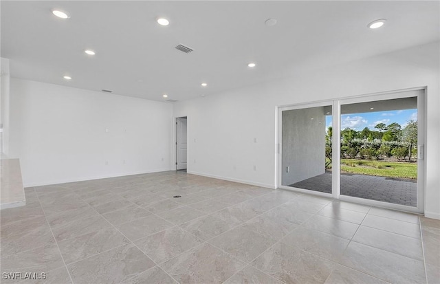 spare room with recessed lighting, visible vents, and baseboards