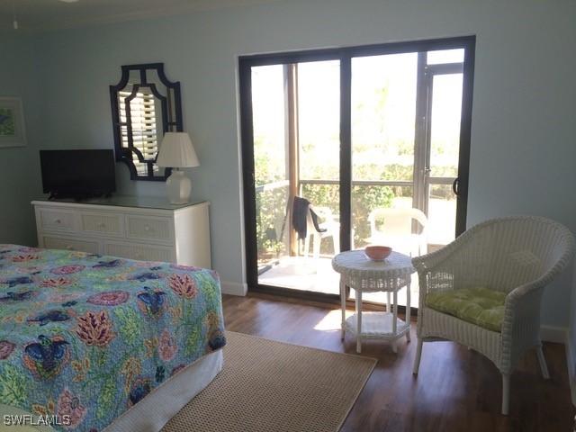 bedroom featuring access to exterior and wood-type flooring