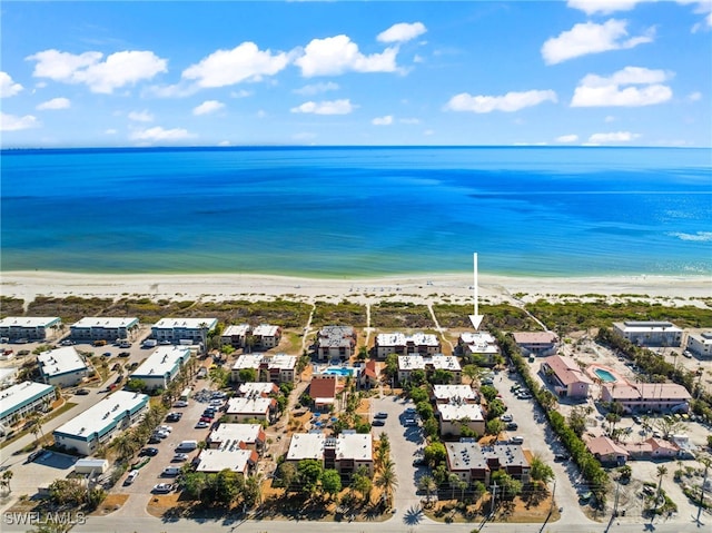 birds eye view of property featuring a beach view and a water view